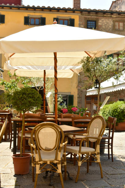 istock Pretty deserted cafe table and chairs 1297047320