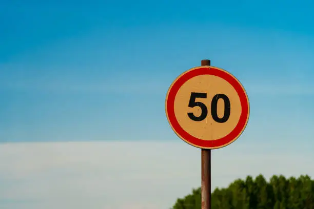 50 speed limit orange road sign