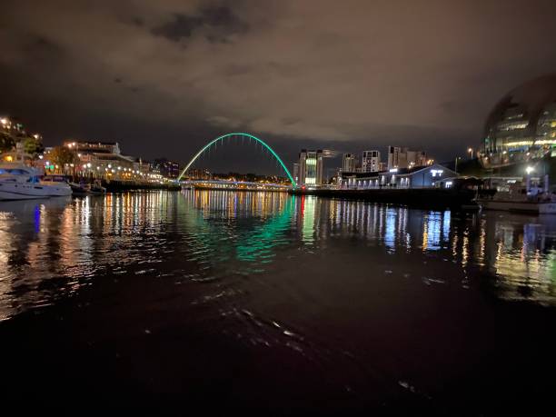 istock Millenium Bridge at night by boat on the river 1297048535