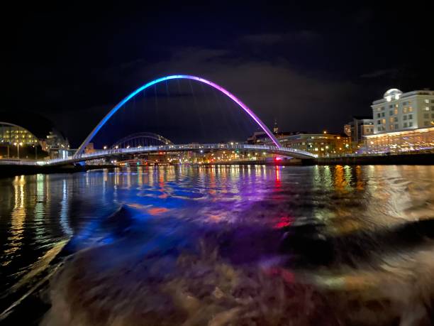 istock Millenium Bridge at night by boat on the river 1297048638
