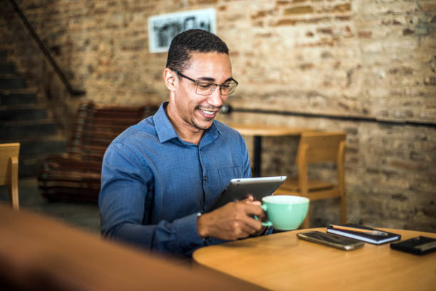 istock Young businessman using a digital tablet in a modern office 1297049763