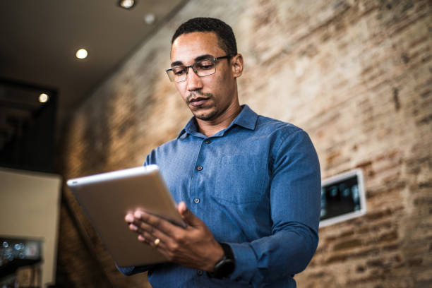 istock Young businessman using a digital tablet in a modern office 1297049942