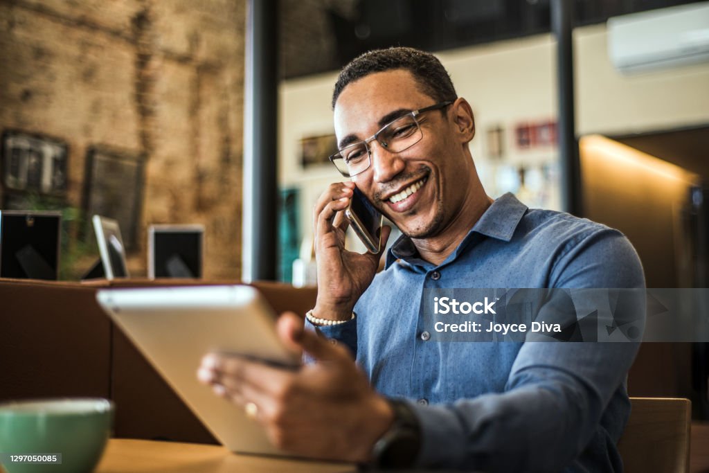 Young businessman using a digital tablet in a modern office Young, businessman, digital, tablet, modern, office Men Stock Photo