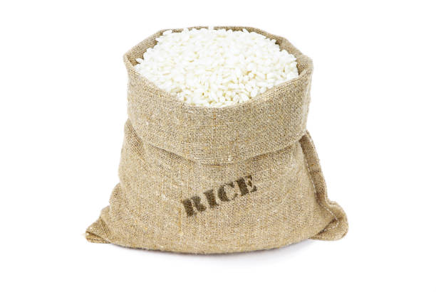 Arborio rice in sack isolated on a white background. White rice in burlap sack. White rice in jute bag. Healthy vegan food.