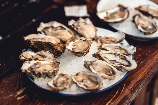 istock Opened Oysters Fines de Claire on plate with ice 1297051511