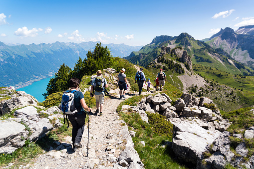 Schynige Platte, Canton of Bern, Switzerland - July 1, 2018 : On the top of the Schynigen Platte. A group of hikers on the ridge above Lake Brienz, Bernese Oberland, Switzerland.