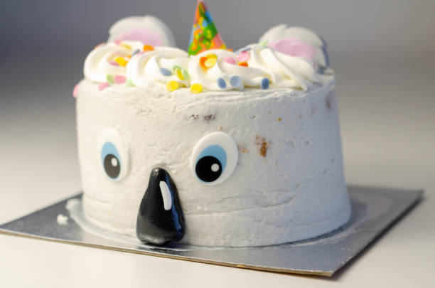 istock Madeira sponge layered with frosting and raspberry jam, covered in soft icing with edible decorations, koala bear-shaped cake, 1297052843