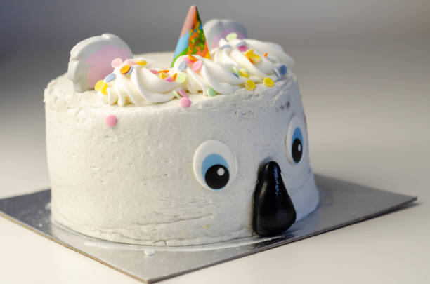 istock Madeira sponge layered with frosting and raspberry jam, covered in soft icing with edible decorations, koala bear-shaped cake, 1297052975