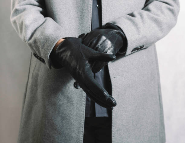 istock Male hands putting on black fur gloves 1297054381