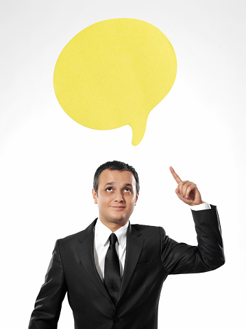 Businessman pointing at adhesive note speech bubble
