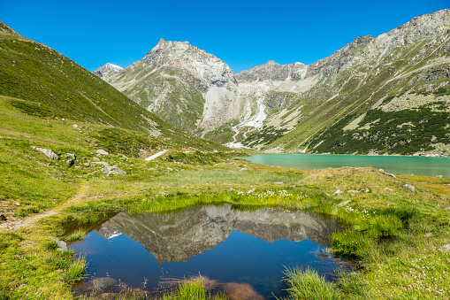 The beautiful high mountain environment of the Riffelsee Riffel Lake) in Pitztal, western Austria, a fascinating mountain lake at 2,232 m. The high mountain in the distance, reflected in the small pool, is Seekogel (3357 m).