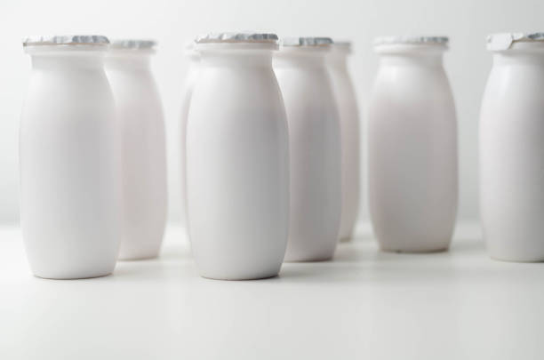 istock White plastic yogurt bottles on white background, typical packaging for dairy products 1297056177
