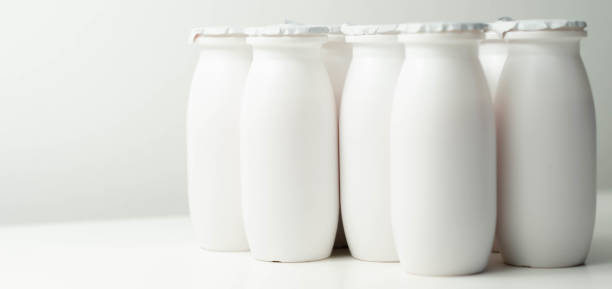 istock White plastic yogurt bottles on white background, typical packaging for dairy products 1297056187
