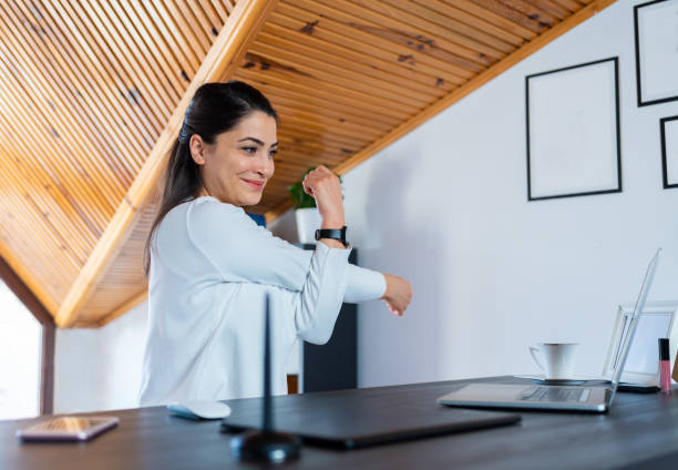 Happy young business woman is doing stretching exercise and practicing office yoga at home office. Happy young business woman is doing stretching exercise and practicing office yoga at home office. ergonomics stock pictures, royalty-free photos & images