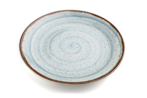 istock Empty blue ceramic plate isolated on white background. Side view, close up. 1297056275