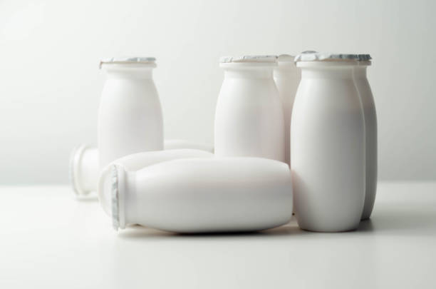 istock White plastic yogurt bottles on white background, typical packaging for dairy products 1297056362