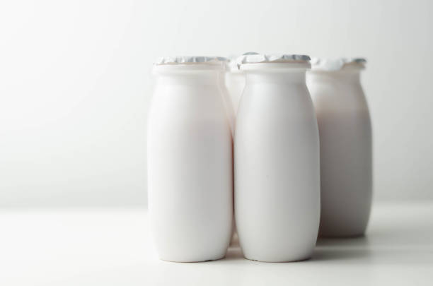 istock White plastic yogurt bottles on white background, typical packaging for dairy products 1297056955