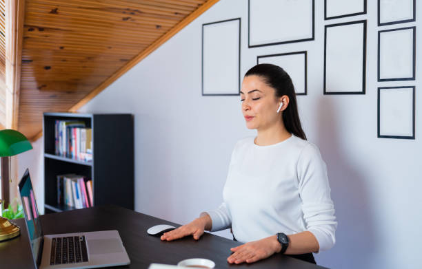 Relaxed calm business woman take deep breath of fresh air resting with eyes closed at work in home office. Doing office yoga and meditating with closed eyes. Relaxed calm business woman take deep breath of fresh air resting with eyes closed at work in home office. Doing office yoga and meditating with closed eyes. breathing exercises stock pictures, royalty-free photos & images