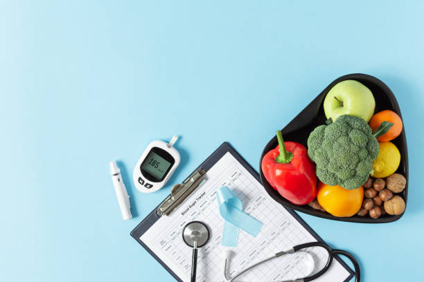 istock Fresh vegetables and fruit with glucometer top view on blue background. 1297057006