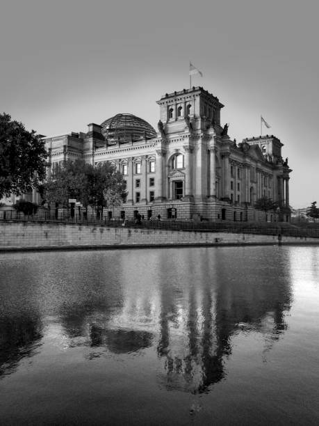 istock view to german Reichstag in Berlin with reflection in river Spree 1297057475