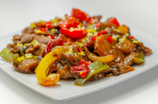 istock Cooked marinated beef slices with a savory black beef sauce, peppers and onions 1297058441