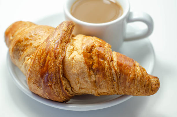 istock Croissant with chocolate on a plate with coffee in a cup 1297059249