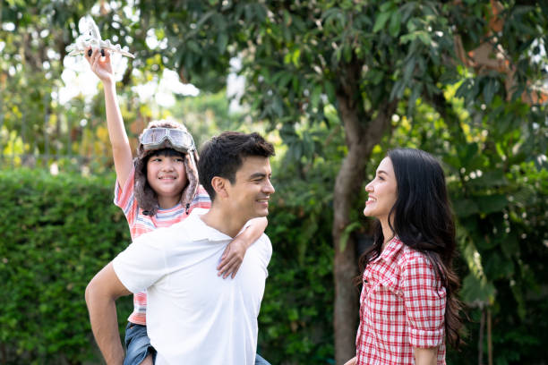 istock Happy family relaxes in the front lawn on a weekend together. 1297059430