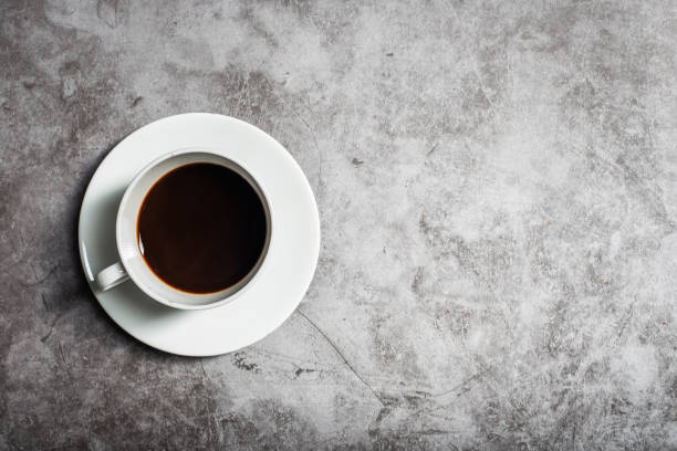 istock Background Coffee cup and beans on old kitchen table. Top view with copyspace for your text 1297061700