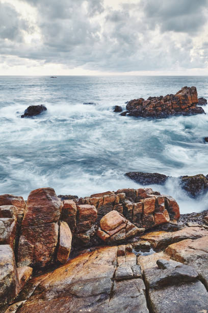 istock Rocky beach, color toned long exposure picture. 1297061732