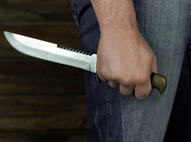 istock man with a knife in his hand in the dark 1297062945