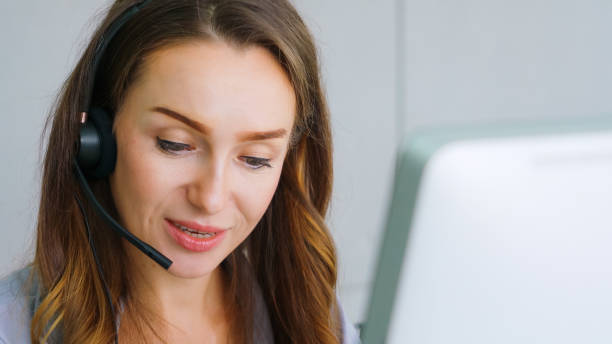 istock Business people wearing headset working in office 1297063070