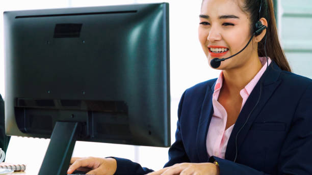istock Business people wearing headset working in office 1297063809