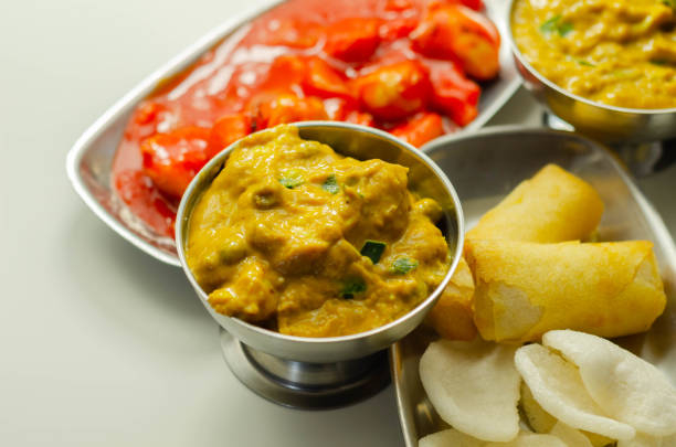 Chinese set,  chicken curry, sweet and sour chicken served with egg fried rice, vegetable spring rolls, and prawn crackers