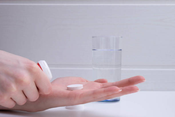 istock female hand lays down a tablet on the palm on a gray background 1297064107