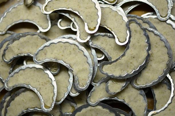 istock female hands fill aluminium cake molds with nut dough 1297064125