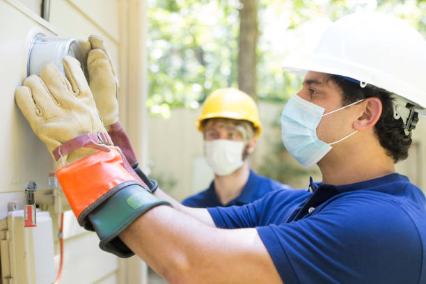 istock Electrical repair man working on outside meter of home. 1297064325