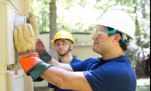 istock Electrical repair man working on outside meter of home. 1297064444
