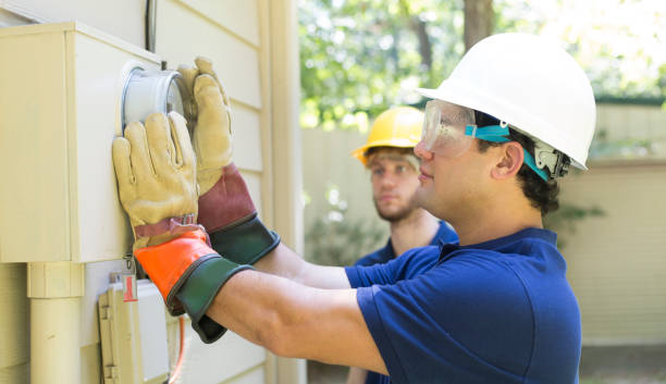 istock Electrical repair man working on outside meter of home. 1297064457
