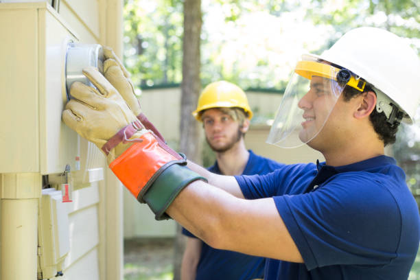 istock Two repairmen work on new cable box connections. 1297064532