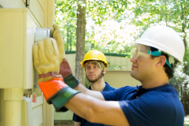 istock Electrical repair man working on outside meter of home. 1297065264