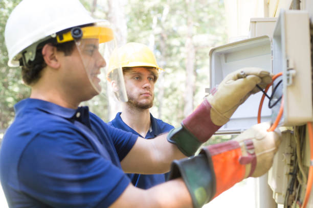 istock Two repairmen work on new cable box connections. 1297065378