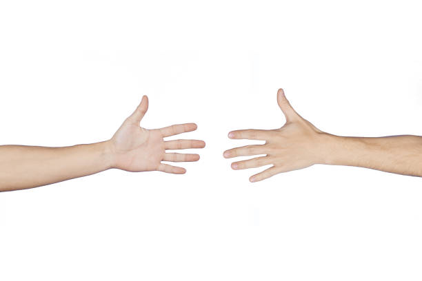 istock Two men's hands about to say hello. Cropped on a white background. 1297065720