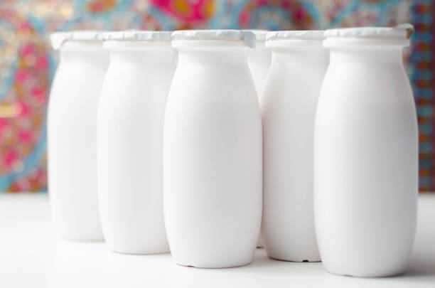 istock White plastic yogurt bottles on colorful background, typical packaging for dairy products 1297066776