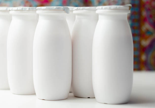 istock White plastic yogurt bottles on colorful background, typical packaging for dairy products 1297067321