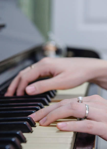 istock a woman is playing a piano 1297067590