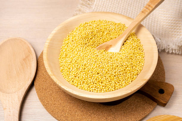 istock Raw millet groats on wooden background. space for text 1297067645
