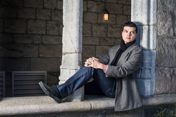 istock A young guy is sitting on a old window frame in New York City, relaxing. 1297067827