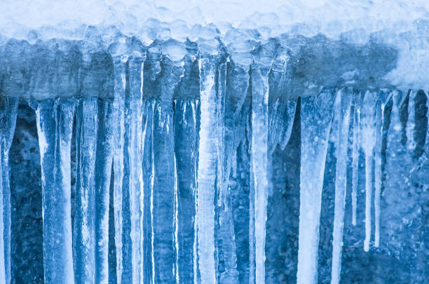 istock Icicles hanging against a background of wall 1297074504