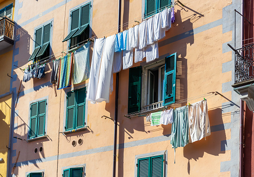 Laundry drying on clotheslines outside the windows of apartment in the town of Riomaggiore, one of the 'Cinque Terre' towns in northern Italy's Liguria region.