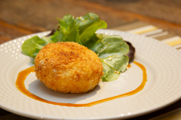 istock Ballotine de chevre (goat cheese, French) fried with honey sauce. 1297078596